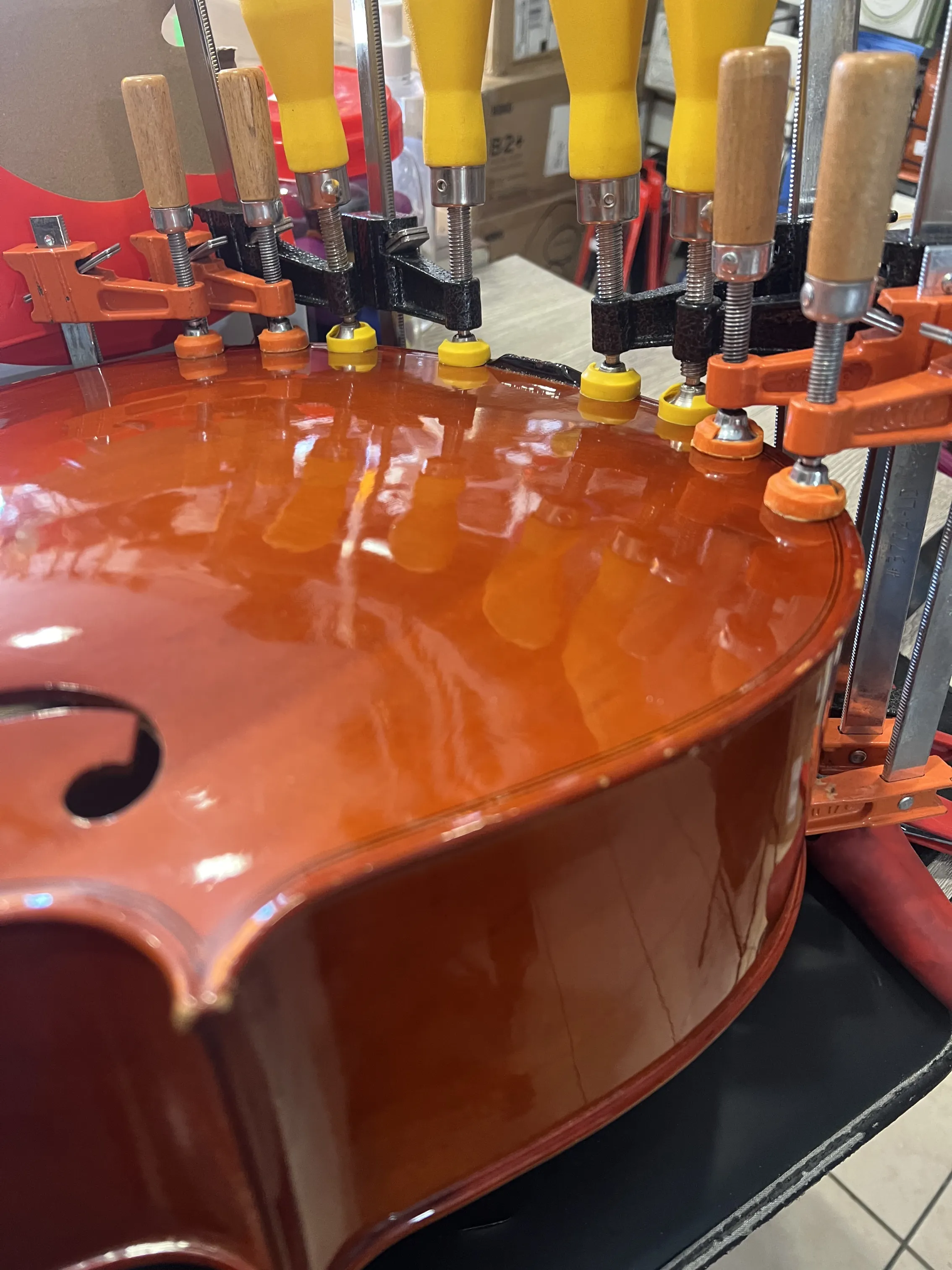 Violin body clamped for a seam reglue on the repair bench